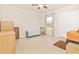 Bright bedroom featuring neutral walls, a ceiling fan, and a window for natural light at 4540 Maverick St, North Port, FL 34288