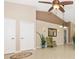 Open-concept foyer with high ceilings, neutral paint, tile flooring, and a decorative rug at 4540 Maverick St, North Port, FL 34288