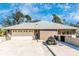 Attached two-car garage with a wide driveway and a well-kept exterior, adding to the property's curb appeal at 4540 Maverick St, North Port, FL 34288