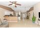 Bright living room featuring an open floor plan, tile floors, high ceilings and a kitchen bar area at 4540 Maverick St, North Port, FL 34288