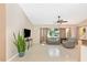 Bright, airy living room featuring tile floors, a ceiling fan, and neutral paint colors with a large window at 4540 Maverick St, North Port, FL 34288