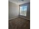 A sunlit bedroom with a large window, neutral walls, and plush carpeting providing a cozy atmosphere at 4802 51St W St # 1210, Bradenton, FL 34210