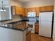 Well-equipped kitchen featuring wooden cabinets, modern appliances, and durable countertop at 4802 51St W St # 1210, Bradenton, FL 34210