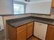 Kitchen featuring dark countertops and wooden cabinets above a white dishwasher and wood floor at 4802 51St W St # 1210, Bradenton, FL 34210