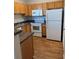 Well-equipped kitchen featuring wooden cabinets, modern appliances, and durable countertop at 4802 51St W St # 1210, Bradenton, FL 34210