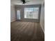 Bright living room with a ceiling fan and a large window with natural light and outdoor views at 4802 51St W St # 1210, Bradenton, FL 34210