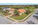 Aerial view of home and community featuring a tile roof, well-manicured lawns, and a beautiful pond at 4802 68Th Street E Cir, Bradenton, FL 34203