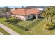 Aerial view of backyard featuring a rod iron fence, manicured lawn, and screened in lanai at 4802 68Th Street E Cir, Bradenton, FL 34203