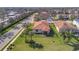 Aerial view of a well-maintained backyard with lush green lawn, landscaping and a black metal fence at 4802 68Th Street E Cir, Bradenton, FL 34203