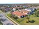 Aerial view of a home with a screened-in pool, lush lawn, mature landscaping and a black metal fence at 4802 68Th Street E Cir, Bradenton, FL 34203