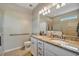 Well-lit bathroom featuring double sinks, granite counters, and a large mirror at 4802 68Th Street E Cir, Bradenton, FL 34203