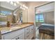 Bright bathroom featuring double vanity, granite countertops, decorative accents and an ensuite bedroom at 4802 68Th Street E Cir, Bradenton, FL 34203