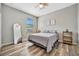 Comfortable bedroom featuring a full-length mirror, ceiling fan, and a minimalist design with lots of natural light at 4802 68Th Street E Cir, Bradenton, FL 34203