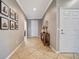 Inviting entryway features tile flooring, decor table, and tastefully framed photographs enhancing the home's character at 4802 68Th Street E Cir, Bradenton, FL 34203