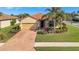 Charming single-story home featuring a tile roof, two-car garage, and well-manicured landscaping at 4802 68Th Street E Cir, Bradenton, FL 34203