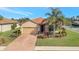 Charming single-story home featuring a tile roof, two-car garage, and well-manicured landscaping at 4802 68Th Street E Cir, Bradenton, FL 34203