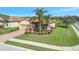 Exterior view of a home with lush landscaping, a brick driveway, and a two-car garage at 4802 68Th Street E Cir, Bradenton, FL 34203