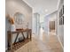 Inviting foyer with tile flooring, decorative table and mirror, neutral paint colors, and stylish accents at 4802 68Th Street E Cir, Bradenton, FL 34203