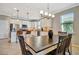 Kitchen featuring white cabinets, stainless steel appliances, an island with bar seating, and a dining table nearby at 4802 68Th Street E Cir, Bradenton, FL 34203