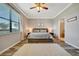 Bright bedroom features a ceiling fan, a large window, and light gray walls at 4802 68Th Street E Cir, Bradenton, FL 34203