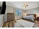 Bright main bedroom features a ceiling fan, a large window, and neutral-colored furniture at 4802 68Th Street E Cir, Bradenton, FL 34203