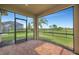 Screened-in patio with brick flooring offers stunning views of the lush green backyard and blue sky at 4802 68Th Street E Cir, Bradenton, FL 34203