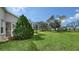 Lush green lawn with views of the conservation land from the screened-in lanai in this home's backyard at 4937 Thames Ln, Sarasota, FL 34238