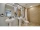 Bathroom featuring dual sinks, updated lighting, tile shower, and vanity at 4937 Thames Ln, Sarasota, FL 34238