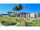 The Siesta Beach pavilion with palm trees, American flag, and manicured landscaping at 4937 Thames Ln, Sarasota, FL 34238