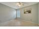 This is a simple bedroom with shutters on the window and tile flooring at 4937 Thames Ln, Sarasota, FL 34238