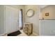 Inviting foyer with tiled floor, a decorative mirror, and a classic wooden dresser at 4937 Thames Ln, Sarasota, FL 34238