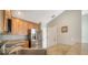 Well-lit kitchen with stainless steel refrigerator, light wood cabinets, and neutral countertops at 4937 Thames Ln, Sarasota, FL 34238