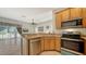 Open kitchen with stainless steel dishwasher and oven, flowing into a brightly lit living area at 4937 Thames Ln, Sarasota, FL 34238