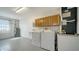 The utility room is equipped with washer, dryer, utility sink, and extra storage at 4937 Thames Ln, Sarasota, FL 34238