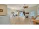 Spacious living room with tile flooring, a ceiling fan, and a sliding door to the patio at 4937 Thames Ln, Sarasota, FL 34238