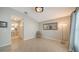 Sunlit living room with tile flooring and access to bathroom, offering a welcoming space at 4937 Thames Ln, Sarasota, FL 34238