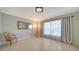 Inviting living room with decorative chair, mirror, tile flooring, and natural light at 4937 Thames Ln, Sarasota, FL 34238