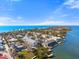 Breathtaking aerial view of waterfront homes with docks along a scenic coastline under a clear blue sky at 5031 N Beach Rd # 222, Englewood, FL 34223