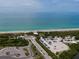 Aerial view of Englewood Beach and a beach parking lot full of cars at 5031 N Beach Rd # 222, Englewood, FL 34223