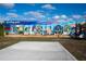 Colorful mural depicting 'Greetings from Englewood', showcasing local scenes and attractions under a bright blue sky at 5031 N Beach Rd # 222, Englewood, FL 34223