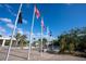 Flags at the Englewood Pioneer Plaza waving in the wind, on a sunny day with a blue sky and light clouds at 5031 N Beach Rd # 222, Englewood, FL 34223