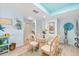 Dining area featuring a glass table with seating and coastal-themed decorations at 5031 N Beach Rd # 222, Englewood, FL 34223