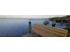 Scenic view of the waterfront from a wooden dock with a comfortable bench at 5031 N Beach Rd # 222, Englewood, FL 34223