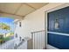 Inviting entrance featuring a blue front door, white textured walls, and stairs leading to stunning water views at 5031 N Beach Rd # 222, Englewood, FL 34223