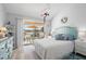 Comfortable bedroom with balcony access and decorative coastal accents at 5031 N Beach Rd # 222, Englewood, FL 34223