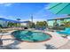 Backyard pool area surrounded by lounge chairs, umbrellas, and well-maintained landscaping for outdoor enjoyment at 5031 N Beach Rd # 222, Englewood, FL 34223