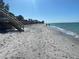 Scenic view of a wide sandy beach with gentle waves, bordered by natural dunes and a stairway at 5031 N Beach Rd # 222, Englewood, FL 34223