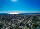 Clear aerial view of the neighborhood and ocean on the horizon on a sunny day at 507 67Th W Ave, Bradenton, FL 34207