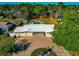 Aerial view of a charming home featuring an expansive backyard pool and a brick driveway at 507 67Th W Ave, Bradenton, FL 34207