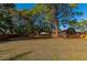 Large backyard with a wood fence and mature trees offers privacy at 507 67Th W Ave, Bradenton, FL 34207